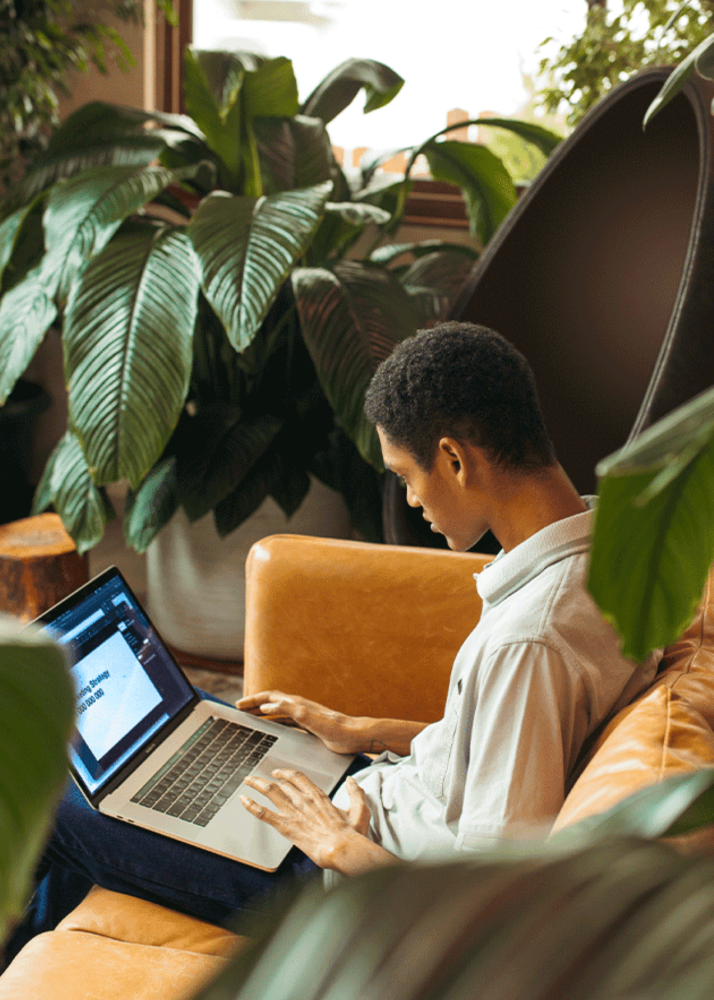 Young man on a couch with a laptop